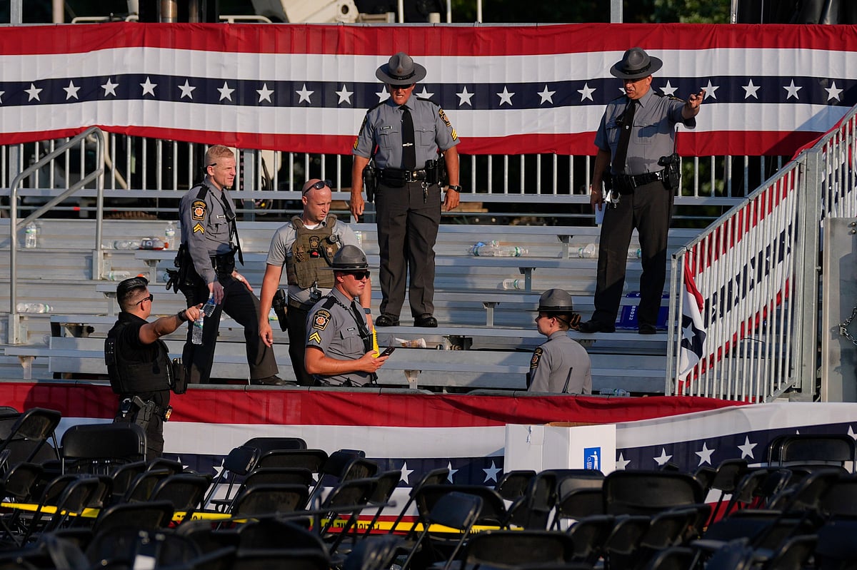 Law enforcement officers gather at the campaign rally site for Republican presidential candidate former President Donald Trump Saturday, July 13, 2024, in Butler, Pa. Trump's campaign said in a statement that the former president was "fine" after a shooting at his rally in Butler  - (AP Photo/Evan Vucci)